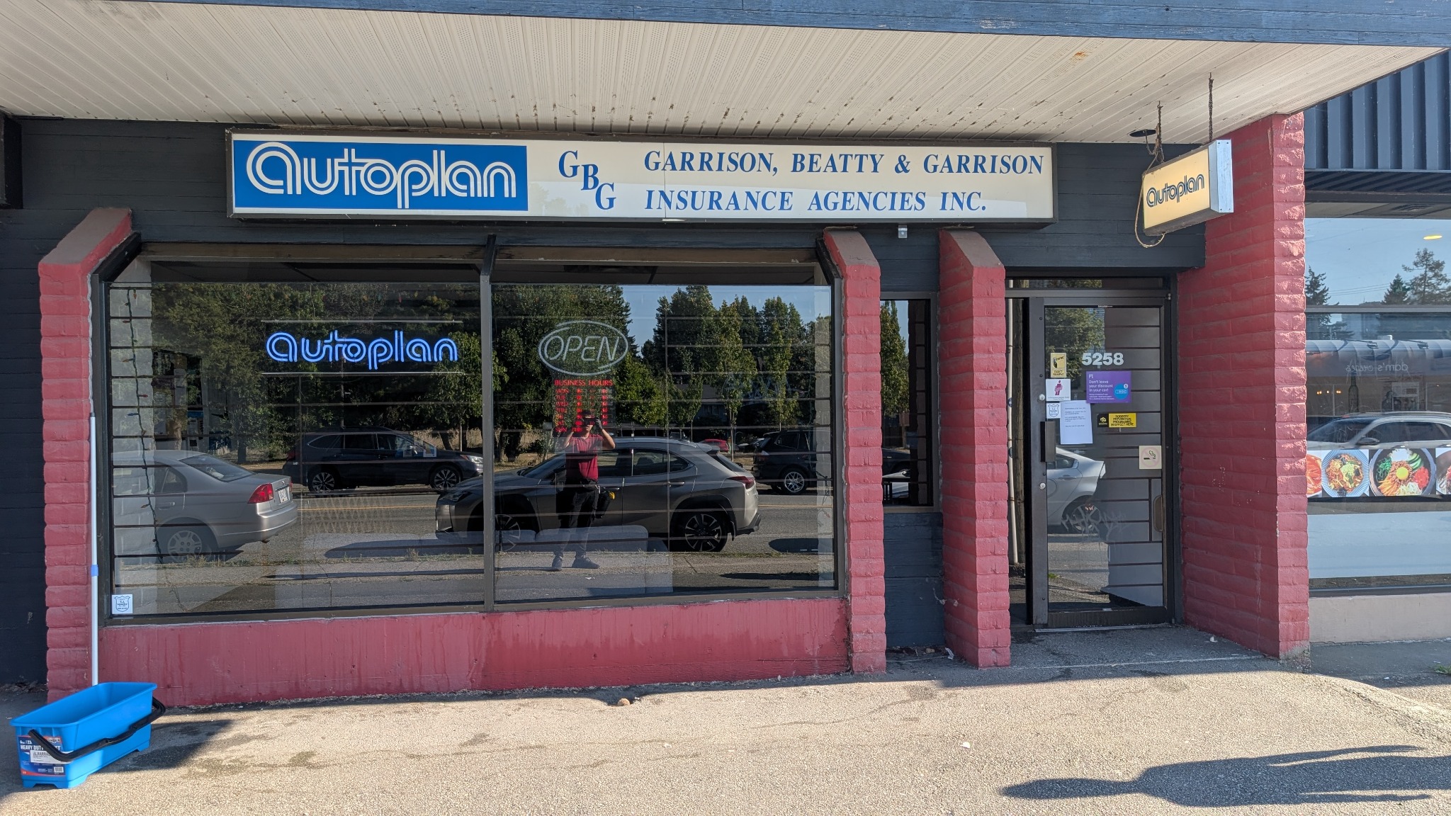 Large exterior sign above commercial storefront windows