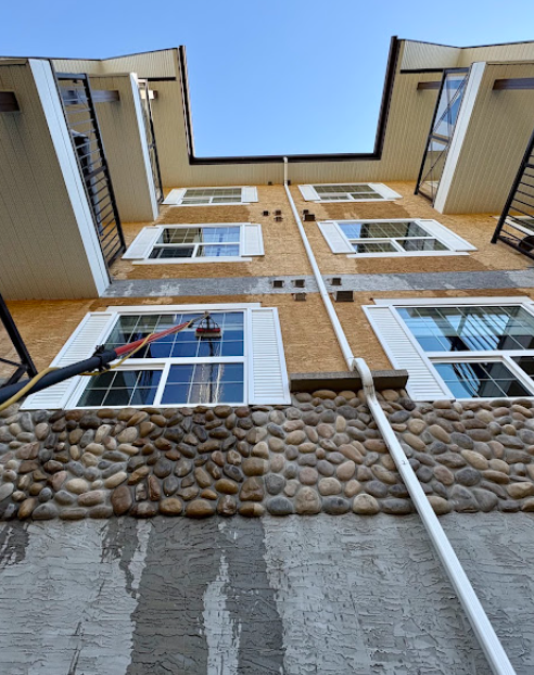 Cleaning upper-floor residential windows with an extension pole